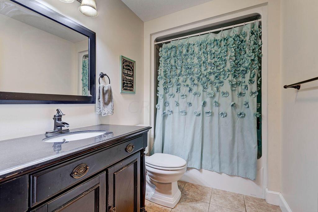 4045 Russell Road Mount Gilead, OH 43338 - Photo 7 of 74 • Ceramic tile flooring • Tan painted walls • Tub/shower combination