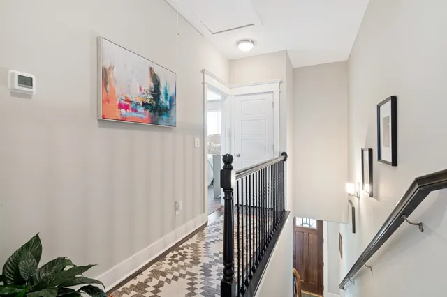 a view of a hallway with wooden floor and entryway