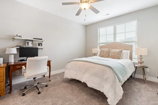 a bedroom with a bed and a desk