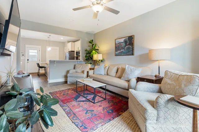 a living room with furniture and a lamp