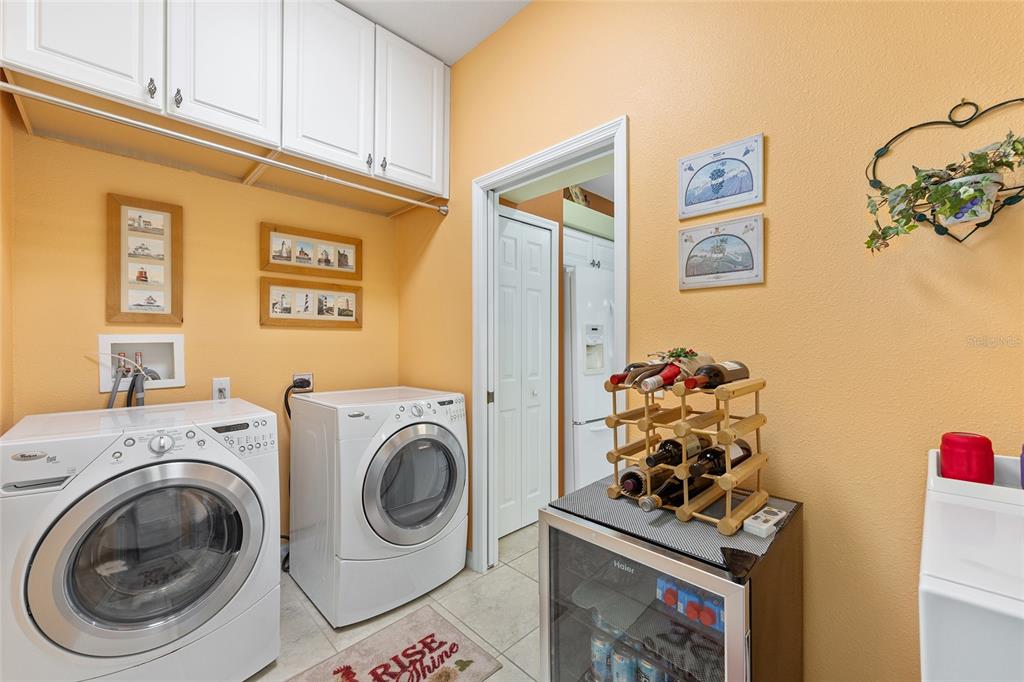 16339 Southwest 14th Avenue Road Ocala, FL 34473 - Photo 17 of 22 a utility room with dryer washer and a view of kitchen