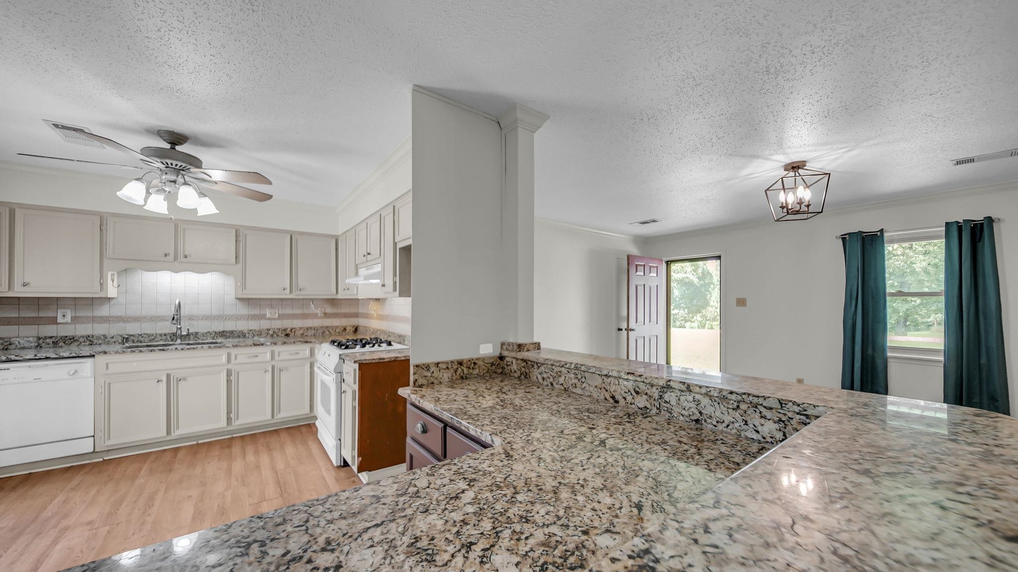 1214 Marshall Road Brighton, TN 38011 - Photo 3 of 19 a kitchen with stainless steel appliances granite countertop a sink stove and refrigerator