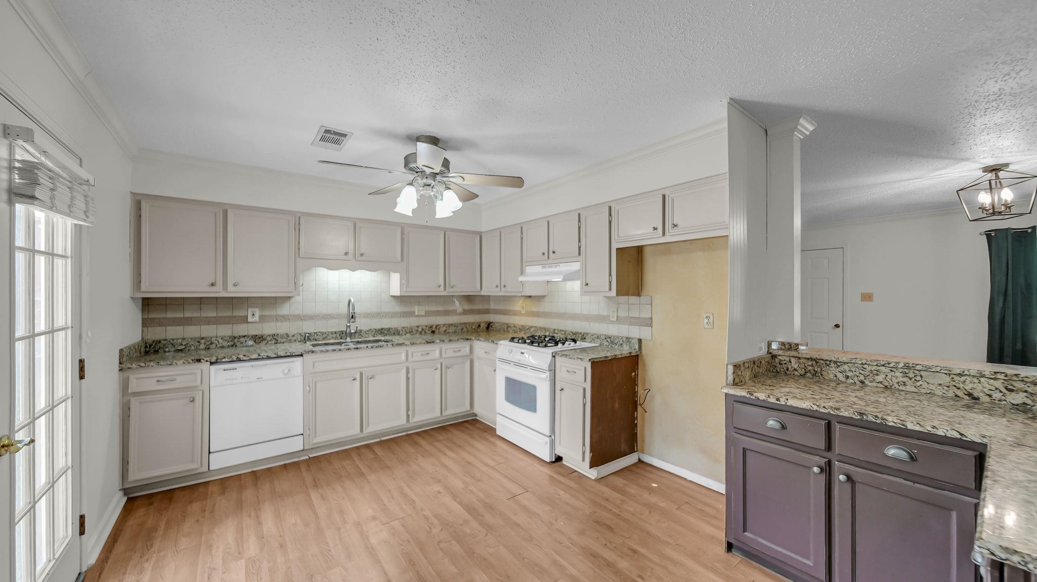 1214 Marshall Road Brighton, TN 38011 - Photo 4 of 19 a kitchen with stainless steel appliances granite countertop hardwood floor sink stove and refrigerator