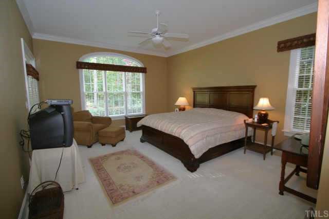 7125 Trenton Ridge Court Raleigh, NC 27613 - Photo 6 of 10 a bedroom with a bed and a chandelier