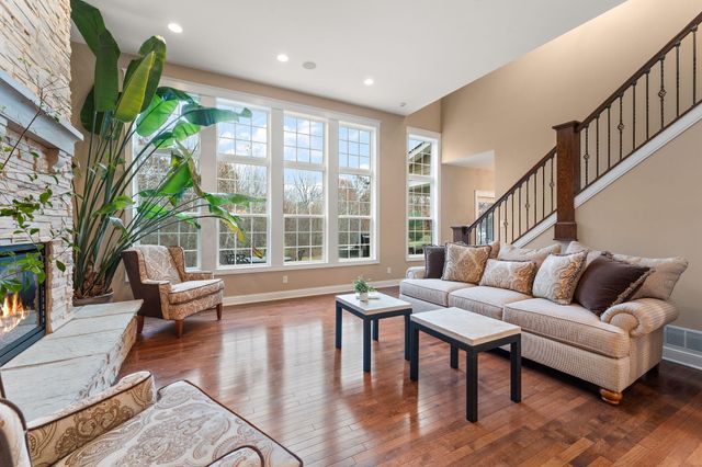 a large kitchen with kitchen island a sink a counter top stainless steel appliances and cabinets