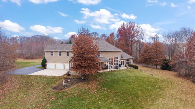 a dining room with furniture a chandelier and wooden floor
