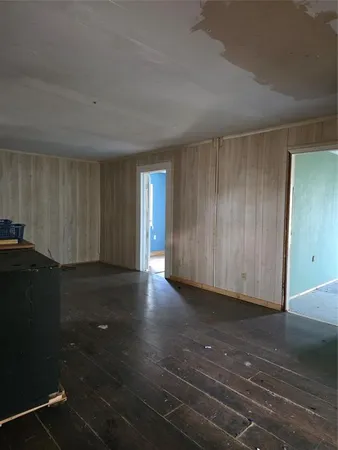 a view of a closet area with hardwood floor
