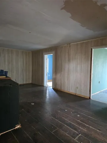 a view of a closet area with hardwood floor