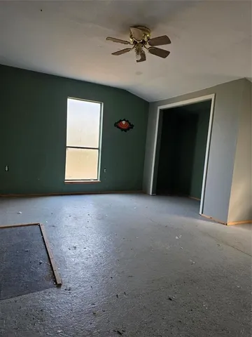 a view of a livingroom with a ceiling fan and window