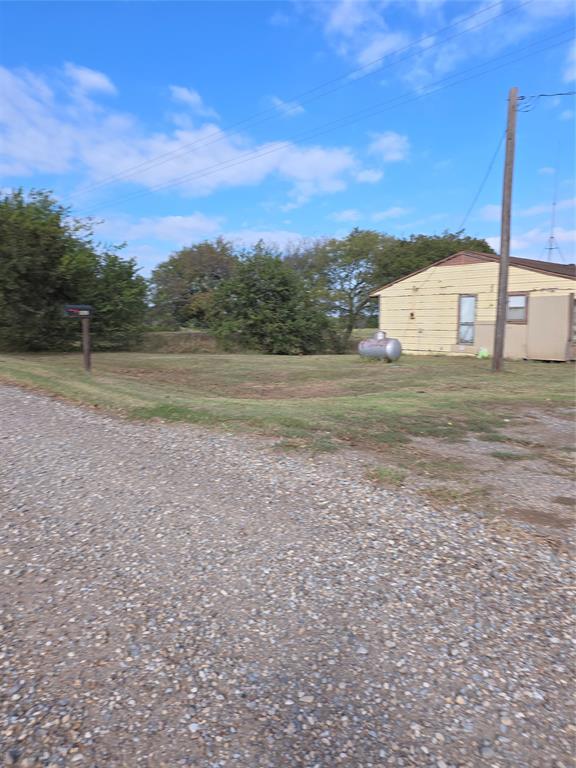 3830 County Road 4040 Whitewright, TX 75491 - Photo 26 of 27 a view of a dry yard with a house
