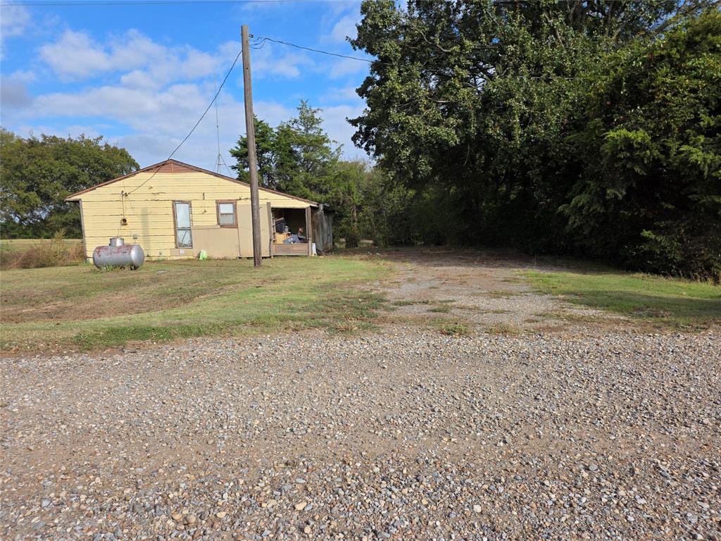 3830 County Road 4040 Whitewright, TX 75491 - Photo 6 of 27 a big house with a big yard and large trees