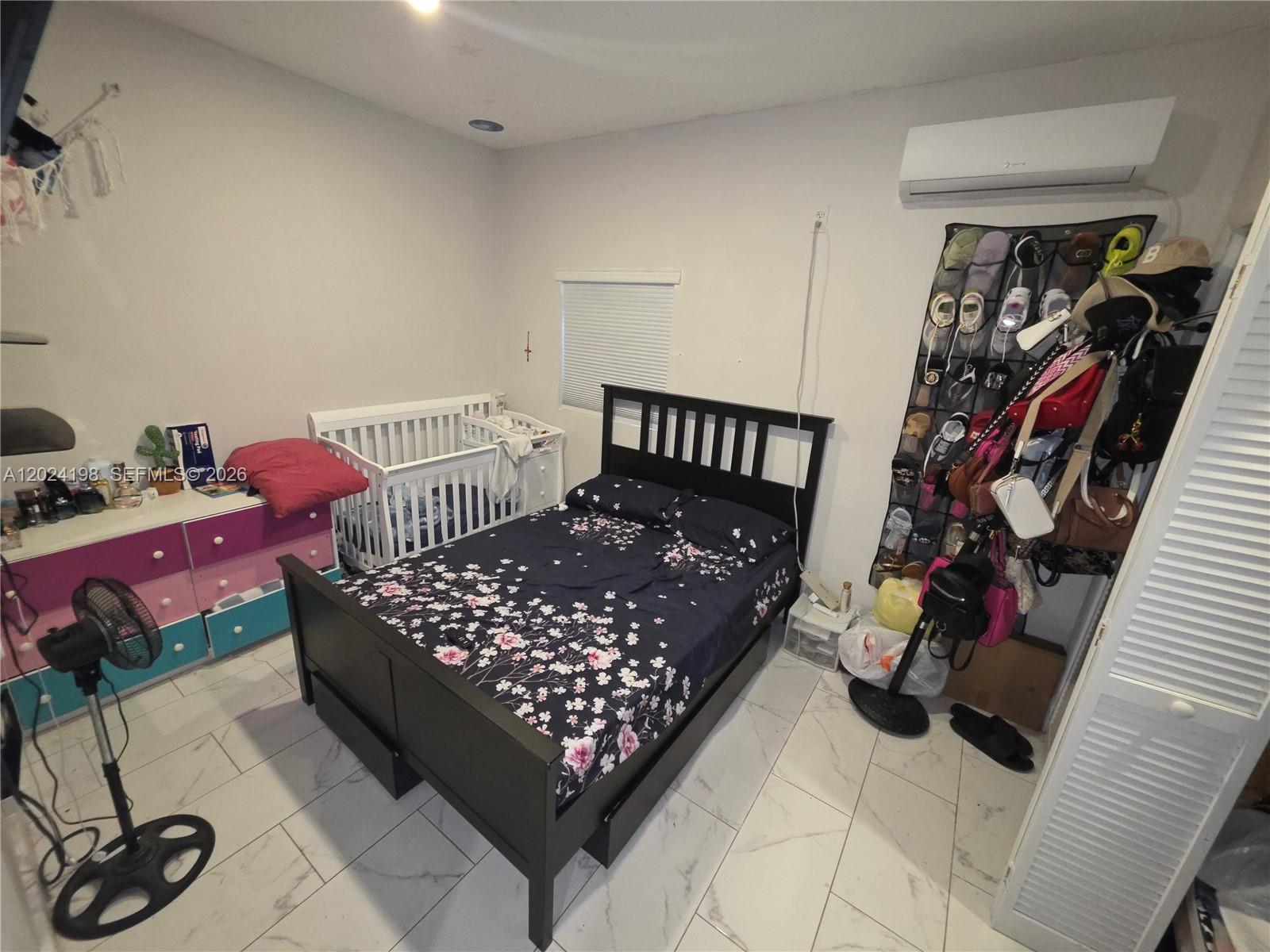651 East 48th Street Hialeah, FL 33013 - Photo 45 of 52 a bed room with a bed and a window