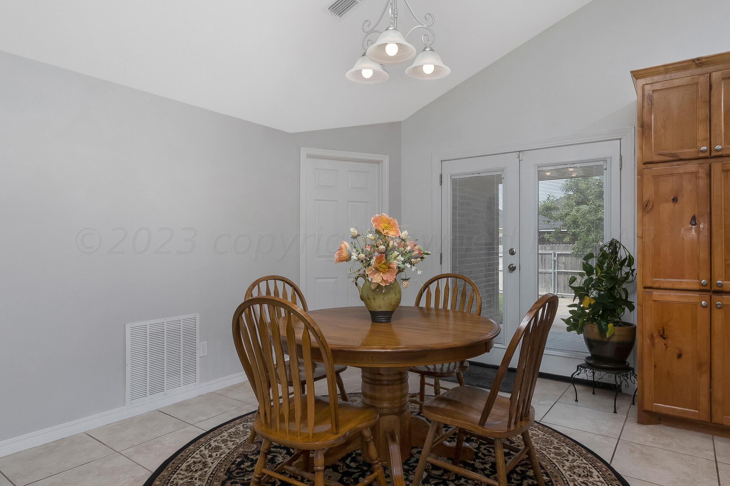 6502 Lexis Street Amarillo, TX 79119 - Photo 11 of 27 a view of a dining room with furniture window and wooden floor