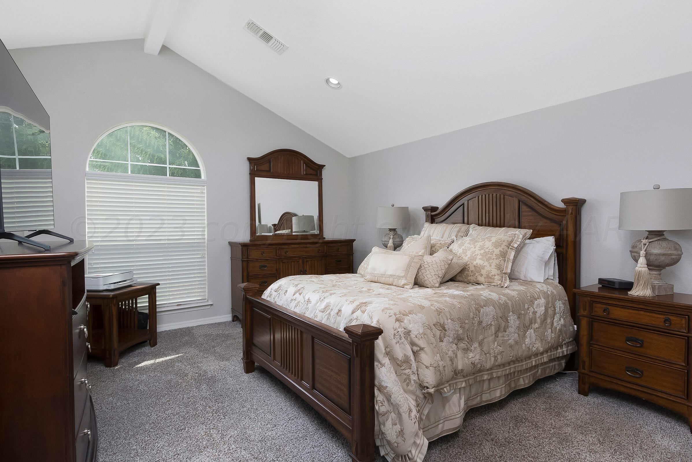6502 Lexis Street Amarillo, TX 79119 - Photo 12 of 27 a bedroom with a bed a lamps and dresser