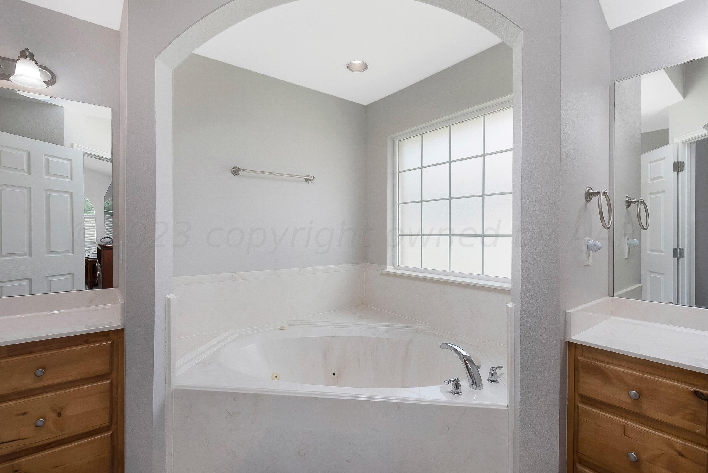 6502 Lexis Street Amarillo, TX 79119 - Photo 13 of 27 a bathroom with a bathtub and a sink
