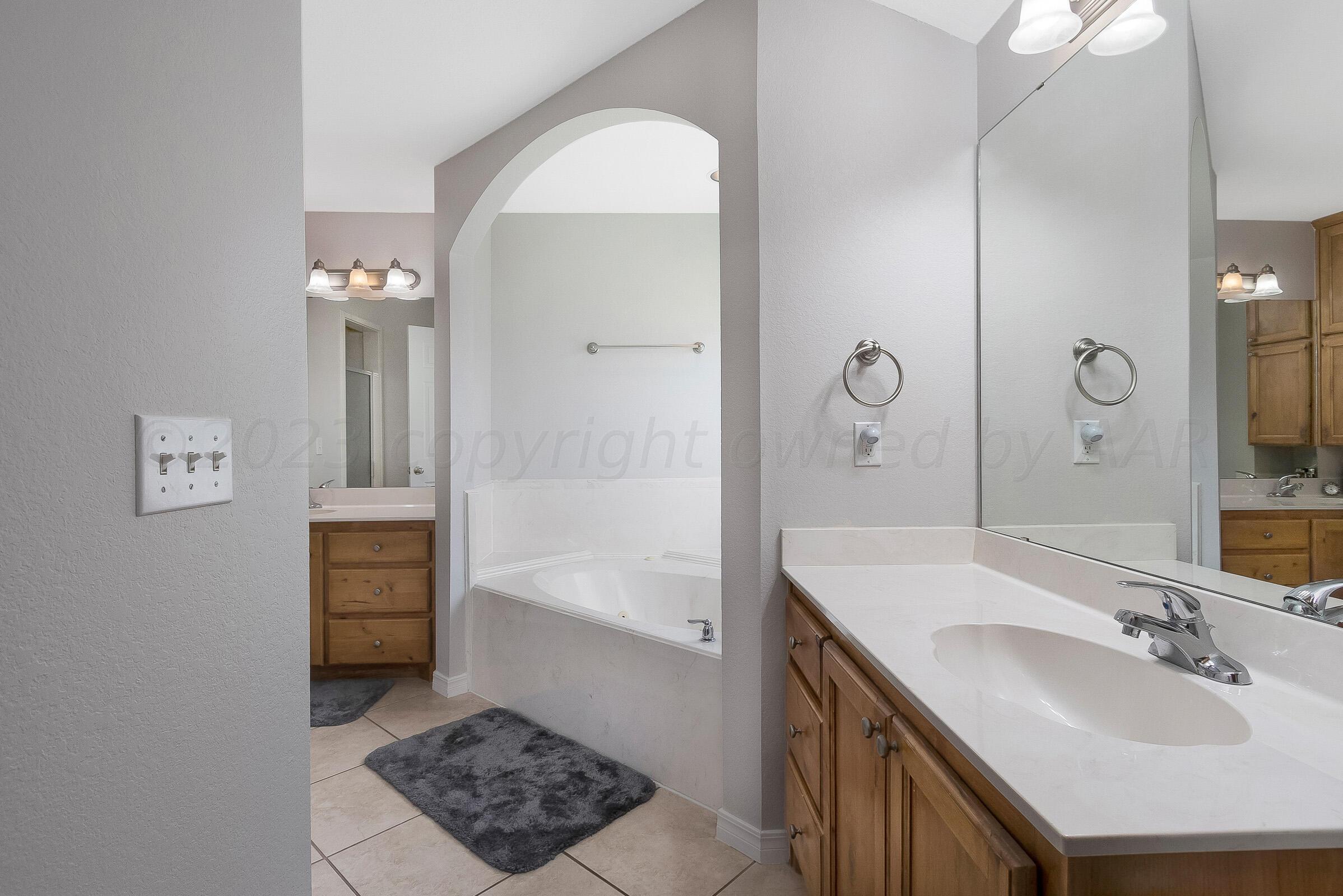 6502 Lexis Street Amarillo, TX 79119 - Photo 14 of 27 a bathroom with a sink a toilet and shower