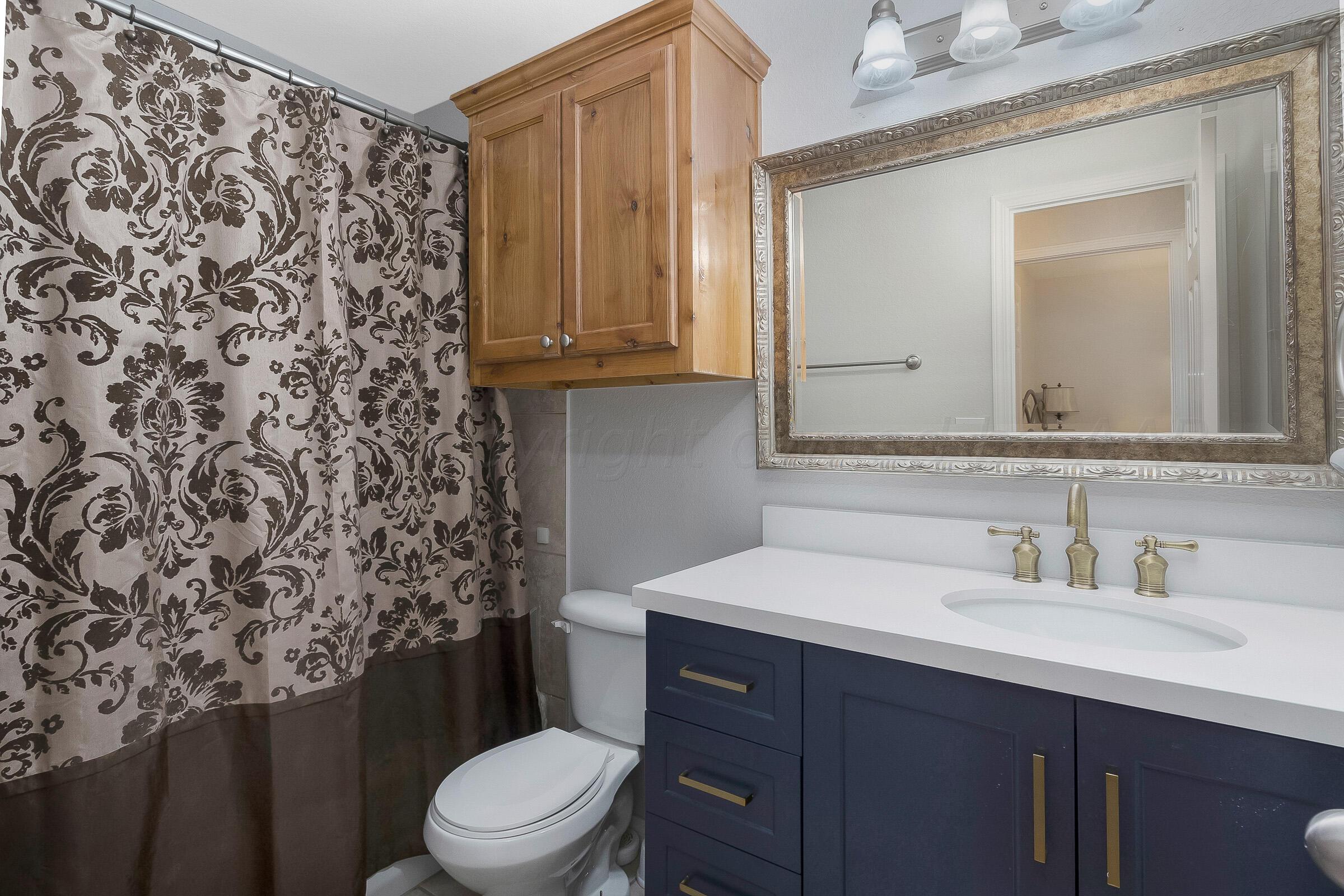 6502 Lexis Street Amarillo, TX 79119 - Photo 17 of 27 a bathroom with a sink toilet and mirror