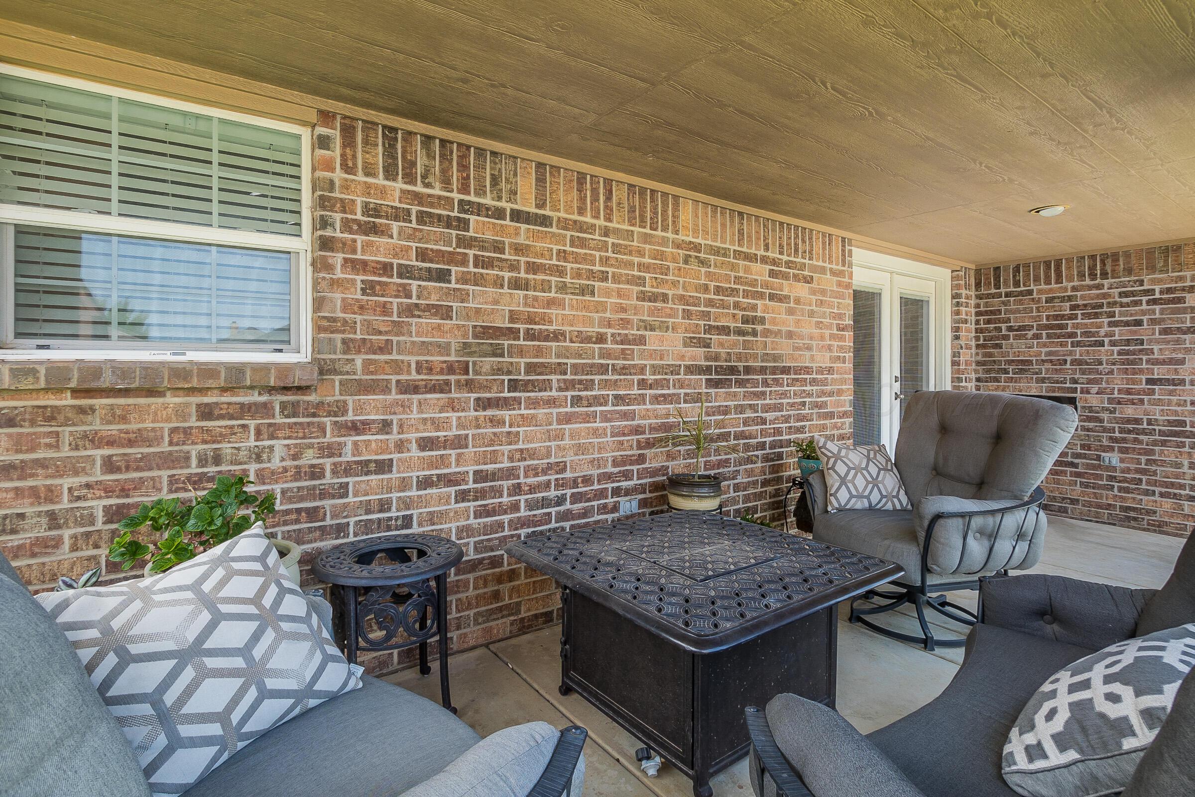 6502 Lexis Street Amarillo, TX 79119 - Photo 21 of 27 a brick house with table and chairs