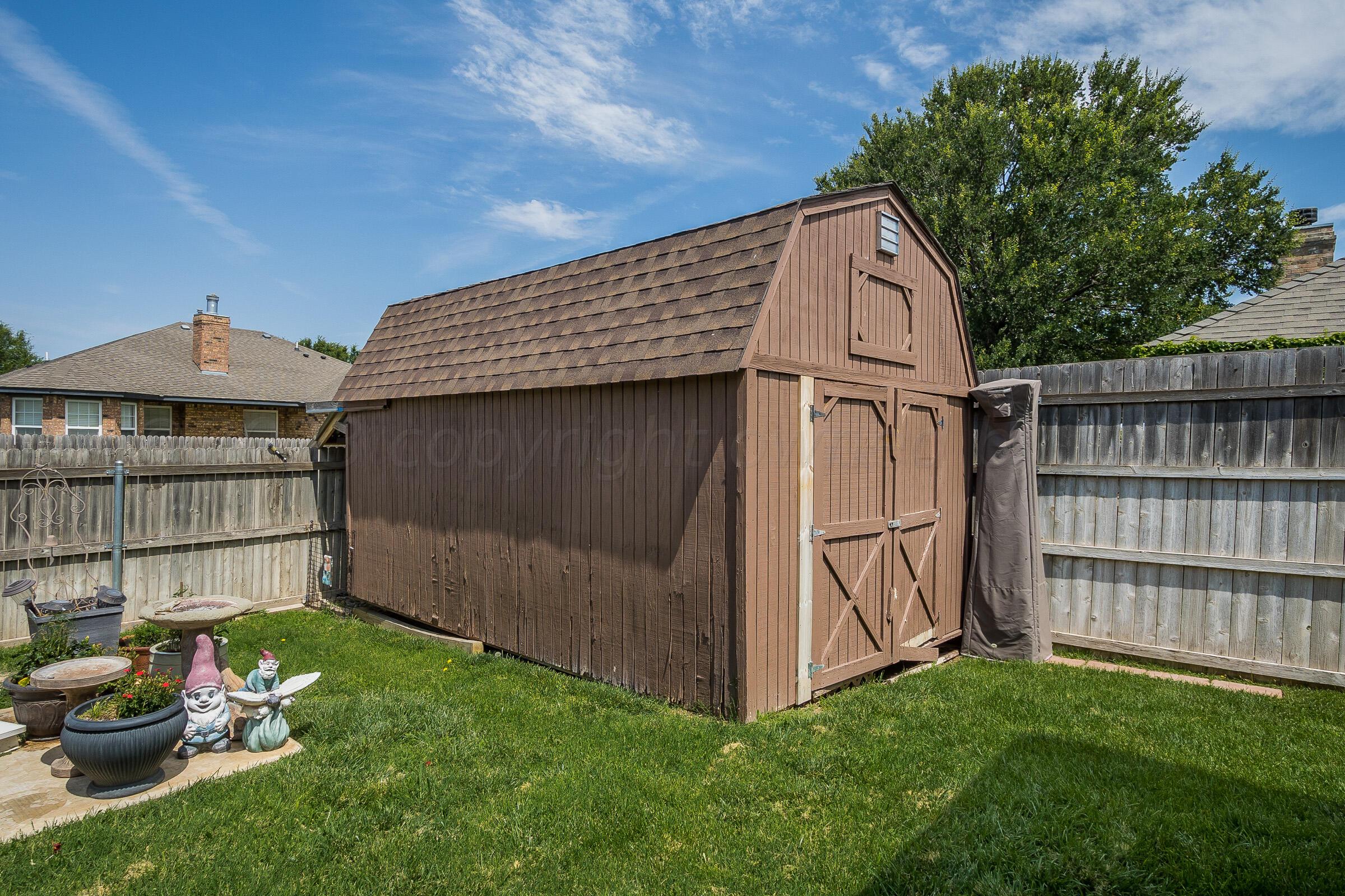 6502 Lexis Street Amarillo, TX 79119 - Photo 24 of 27 a view of backyard with barbeque grill and wooden fence