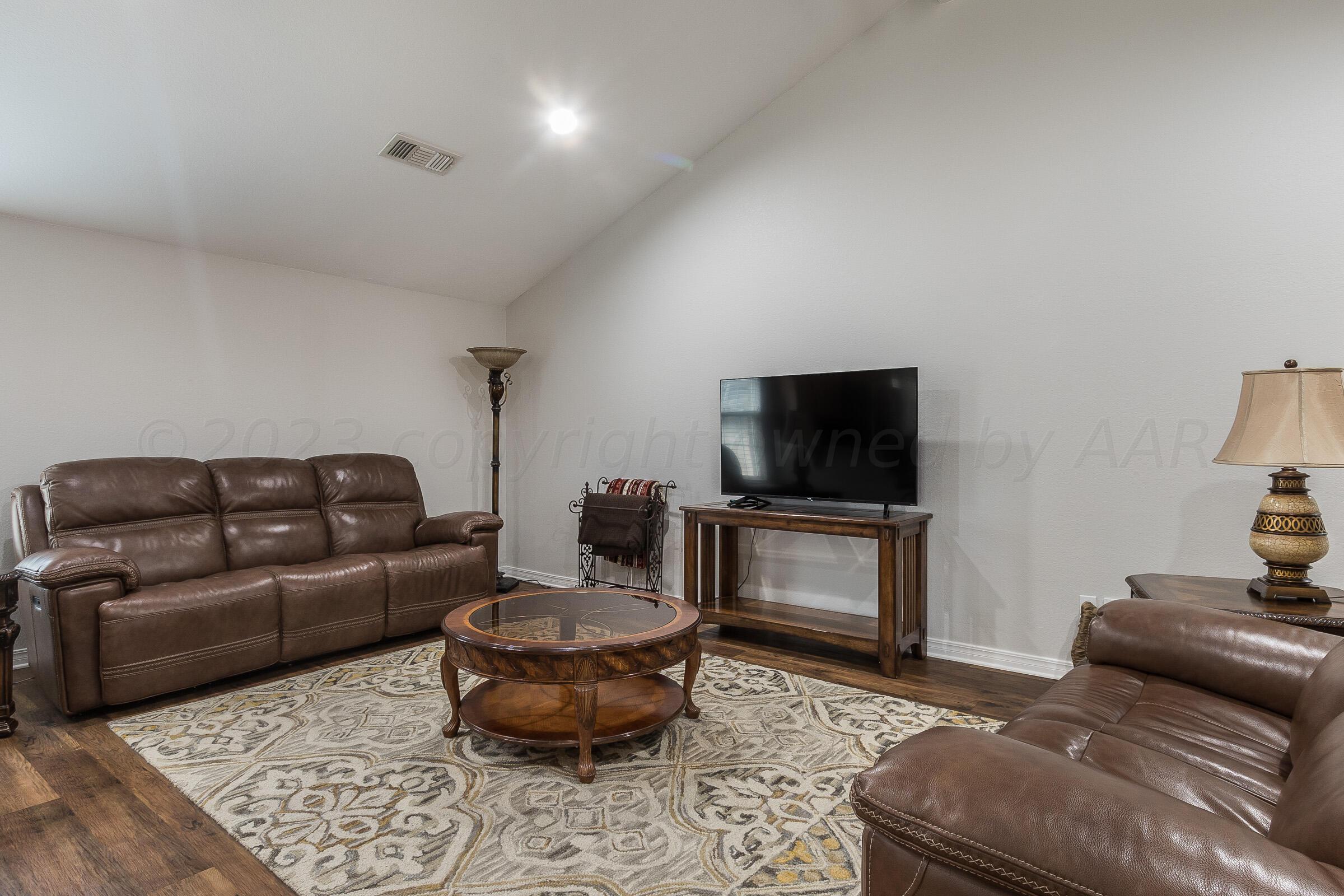 6502 Lexis Street Amarillo, TX 79119 - Photo 4 of 27 a living room with furniture and a flat screen tv