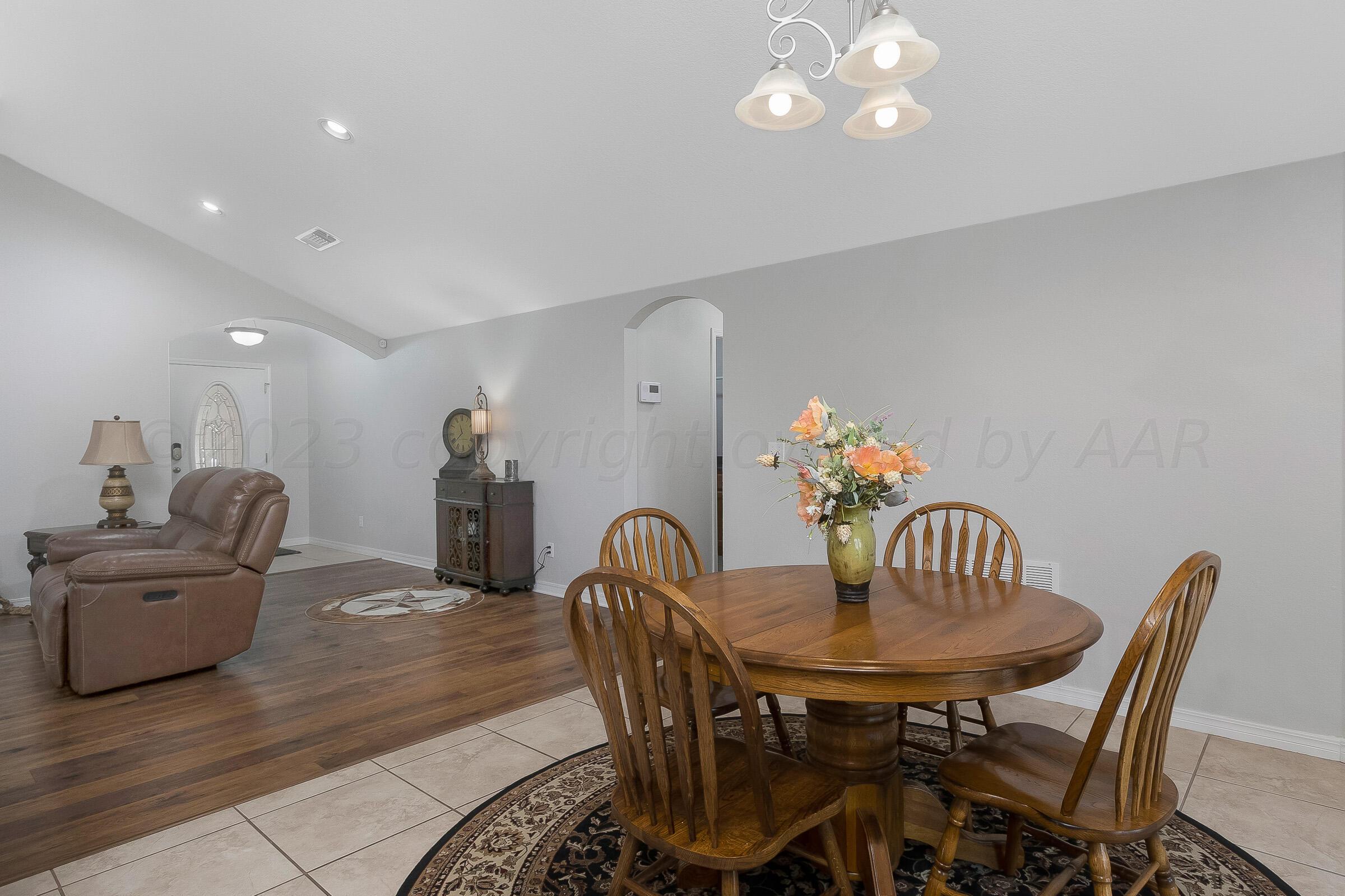 6502 Lexis Street Amarillo, TX 79119 - Photo 10 of 27 a view of a dining room with furniture and wooden floor