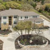 a view of a house with pool and sitting area