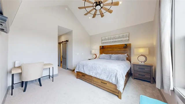 a bedroom with a bed a table and chair