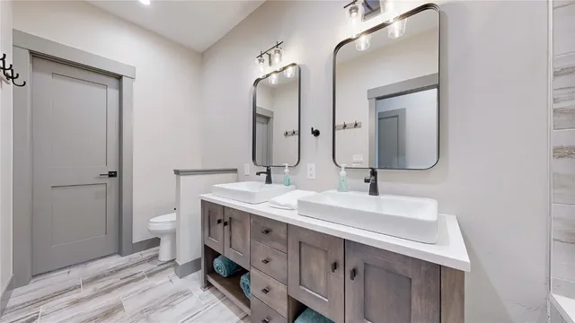 a bathroom with a double vanity sink and a mirror