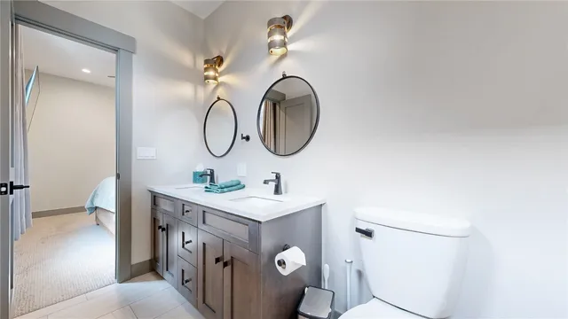a bathroom with a toilet a sink and mirror