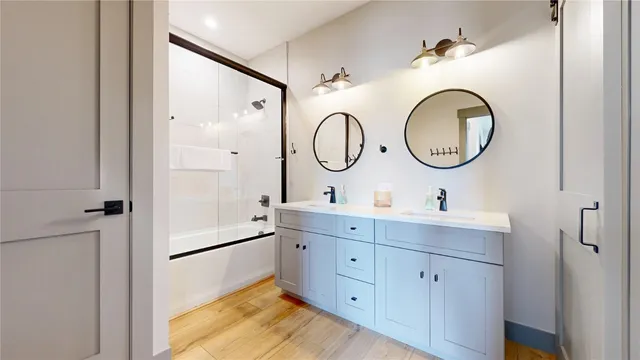 a bathroom with a double vanity sink mirror and a shower