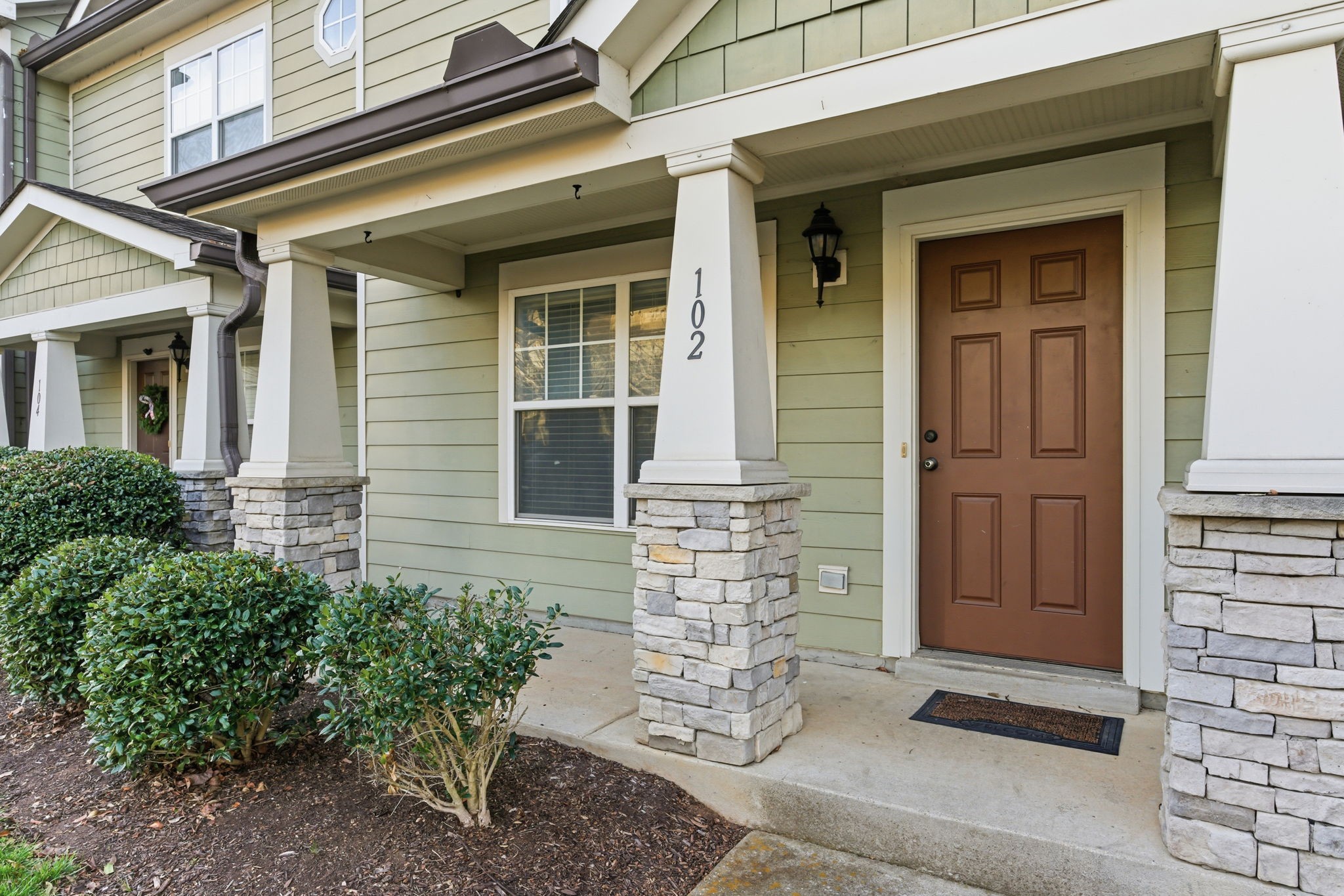 front view of a brick house with a large door
