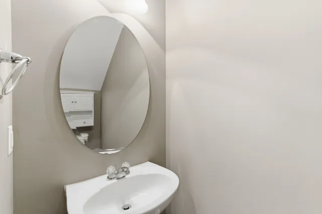 a bathroom with a sink and mirror