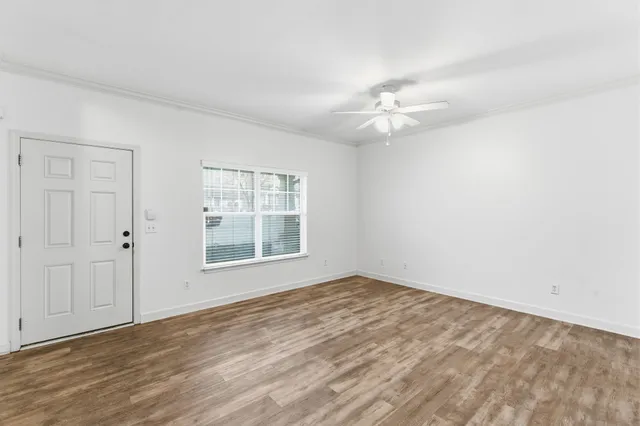 wooden floor in an empty room with a window