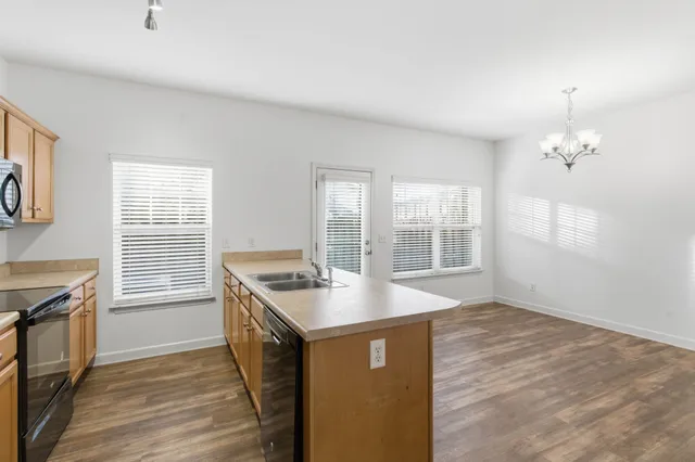 a kitchen with granite countertop a stove and a sink