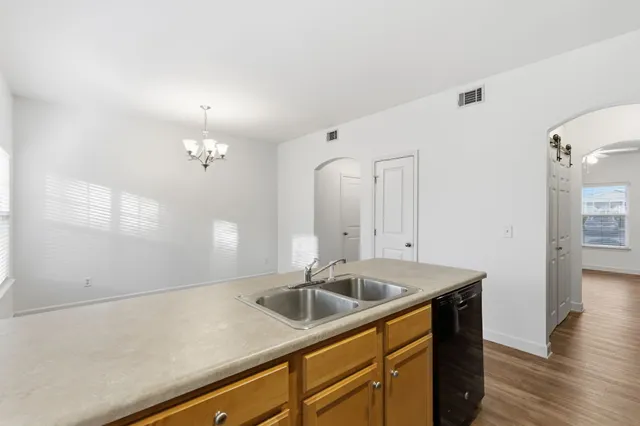 a kitchen that has a sink and cabinets