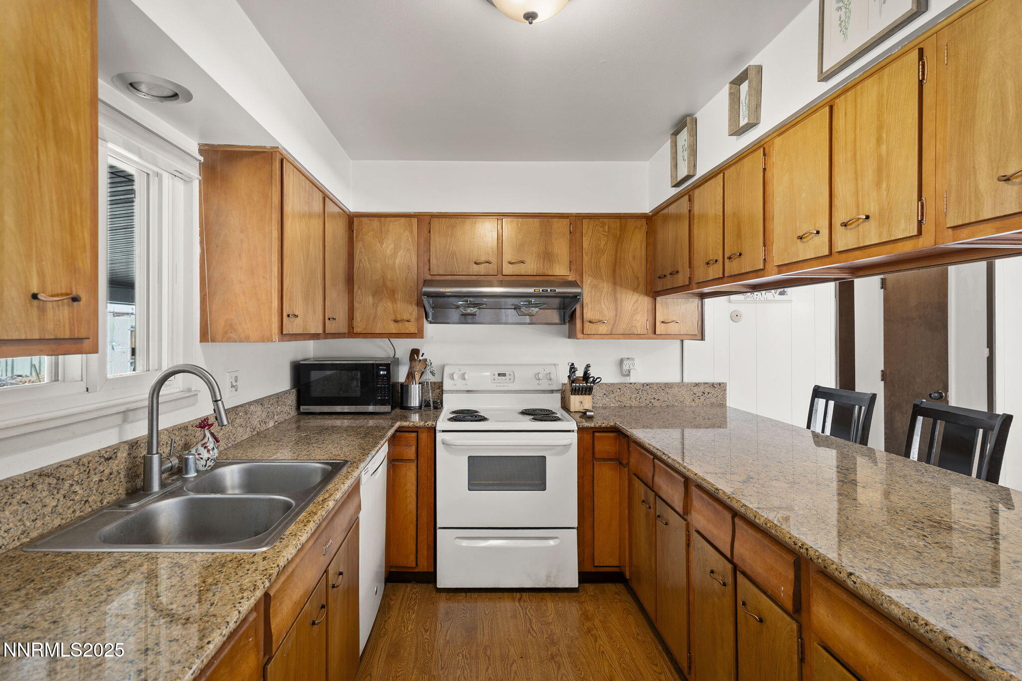 11070 Broken Hill Road Reno, NV 89511 - Photo 18 of 32 a kitchen with stainless steel appliances granite countertop a sink a stove and cabinets