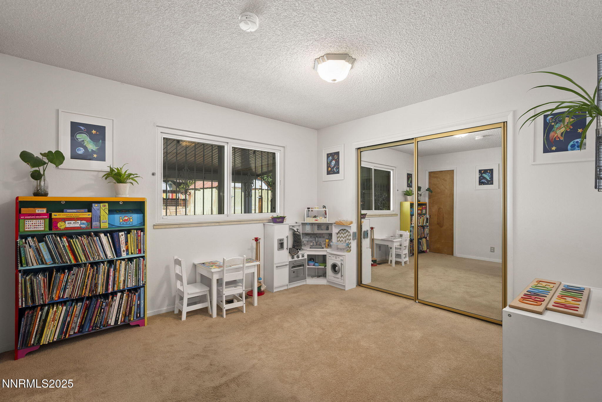 11070 Broken Hill Road Reno, NV 89511 - Photo 25 of 32 a living room with furniture a rug and a book shelf