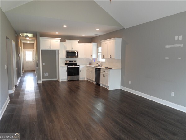 5915 Rye Patch Road Ludowici, GA 31316 - Photo 2 of 25 a view of a kitchen with a sink and a stove top oven