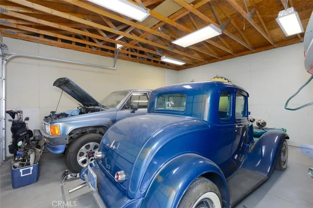 a view of a patio with a table and chairs under an umbrella