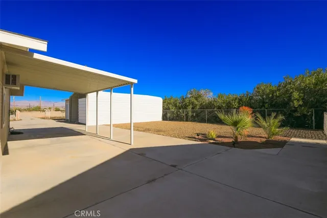 a kitchen with a dining table chairs refrigerator and cabinets