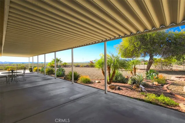 a kitchen with granite countertop cabinets a dining table and a refrigerator