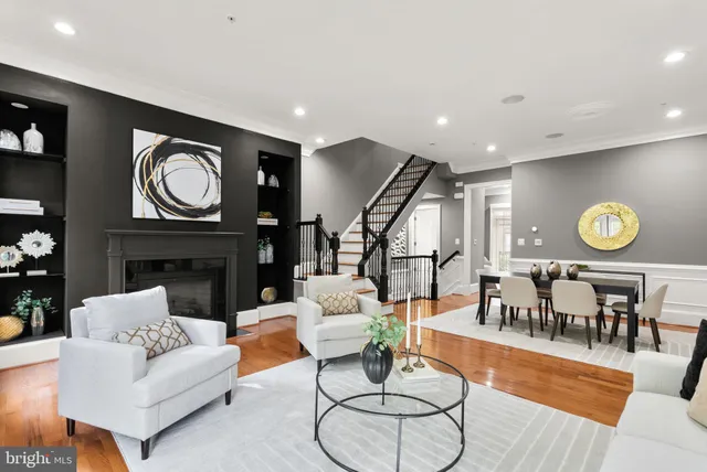 a living room with fireplace furniture and a wooden floor