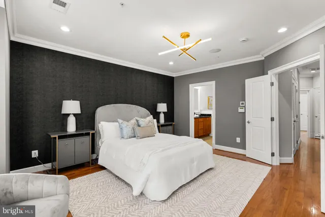 a bedroom with a bed and a chandelier