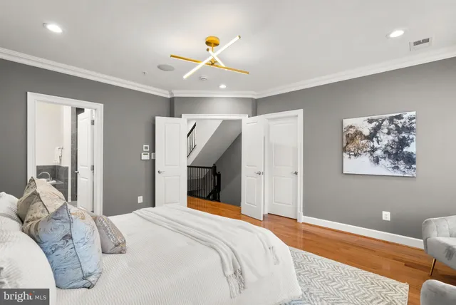 a bedroom with a bed and a painting on the wall