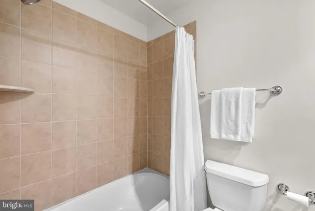 a bathroom with a toilet and shower