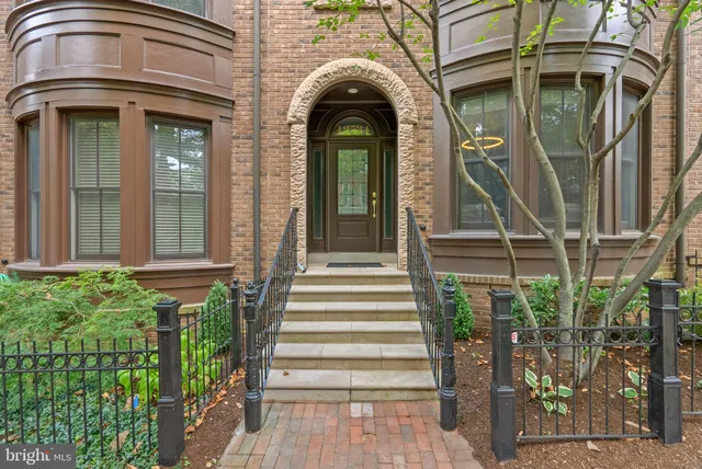 a view of a house with a large windows and plants