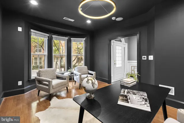 a living room with furniture and floor to ceiling windows