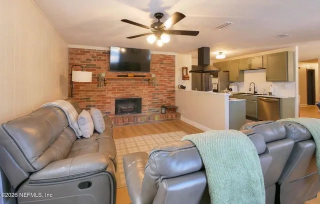 a living room with furniture a fireplace and a flat screen tv