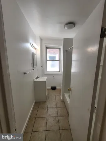 a bathroom with a sink a toilet and window