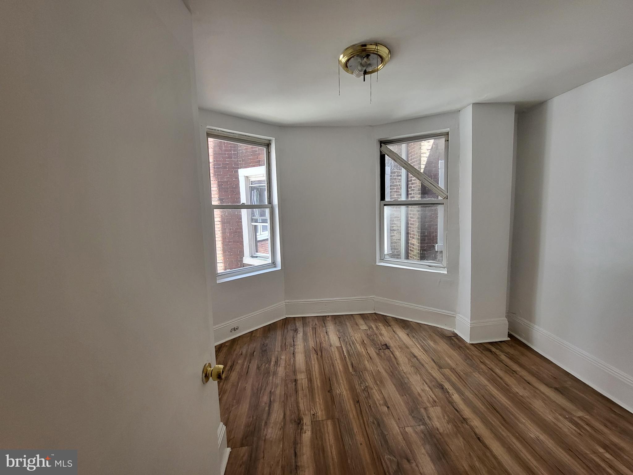 4834 Sansom Street, Unit 1 Philadelphia, PA 19139 - Photo 17 of 23 a view of a room with wooden floor and windows